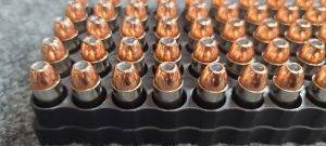10mm 180 gr. XTP Hollow Point bulk remanufactured pistol ammo sitting in ammo trays point up.