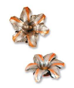 Two metal bullet tips that have been fired and are showing the mushroom effect when the lead fans out.